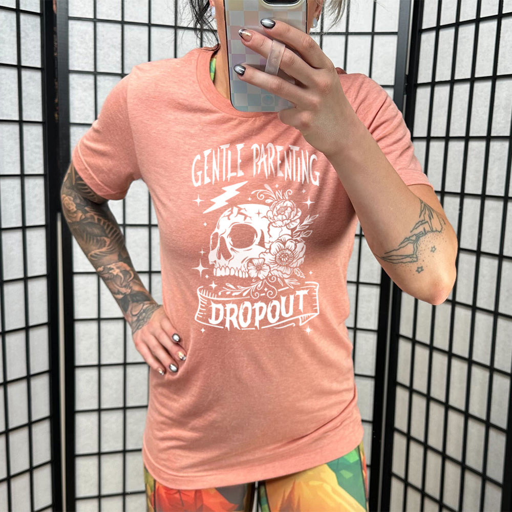 Sunset colored shirt with a skull and flowers graphic on it that says Gentle Parenting Dropout"