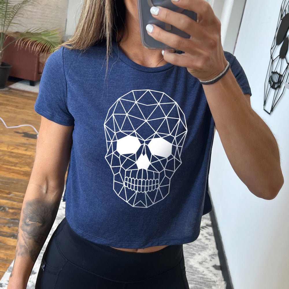 heather navy cropped tee with a geometric skull design on the front in white.