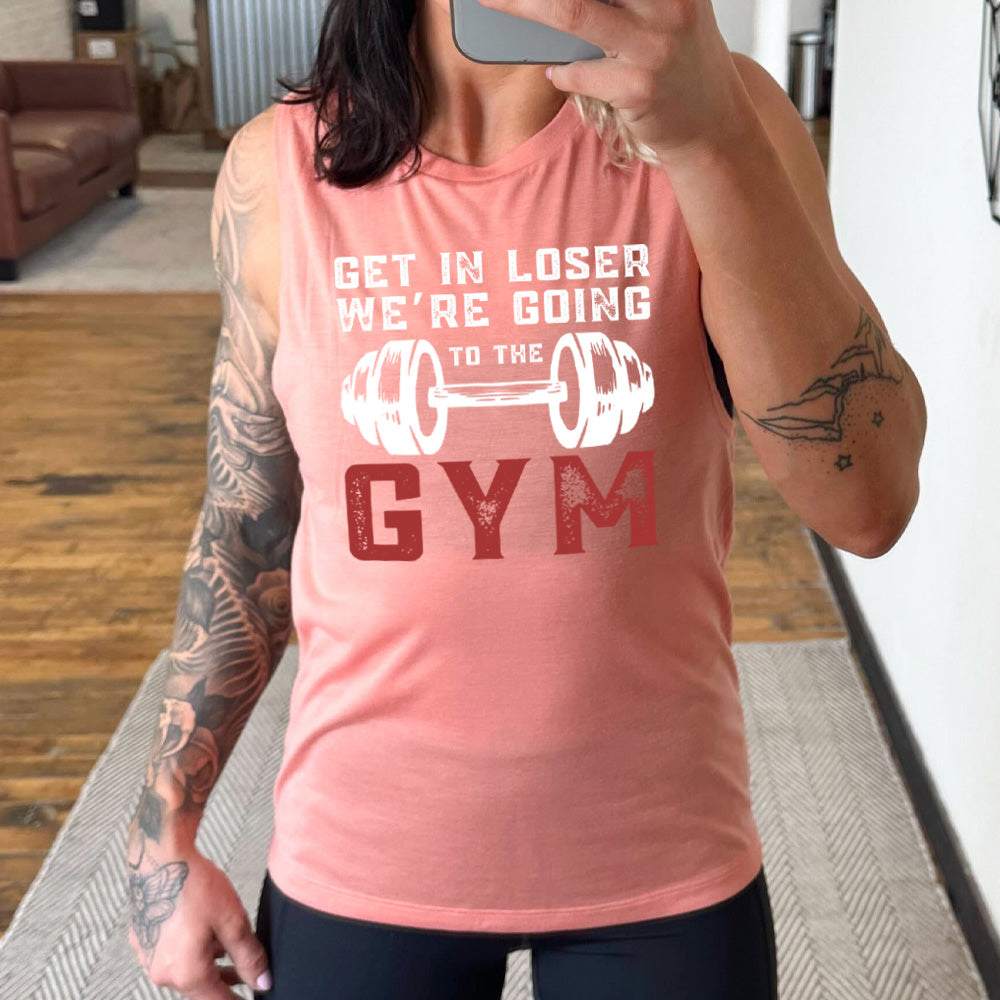 peach muscle tank with the words "get in loser we're going to the gym" with a big barbell graphic
