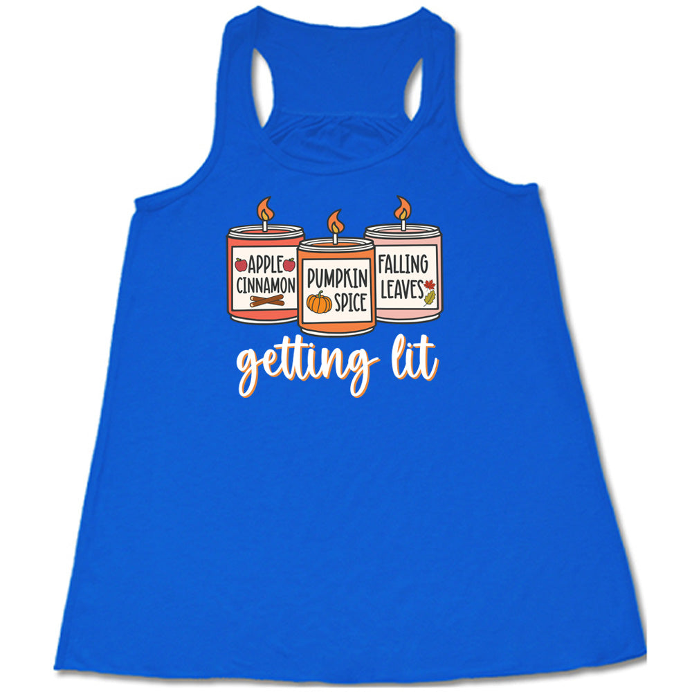 Blue colored flowy tank with fall scented candles graphic on it that says "getting lit"