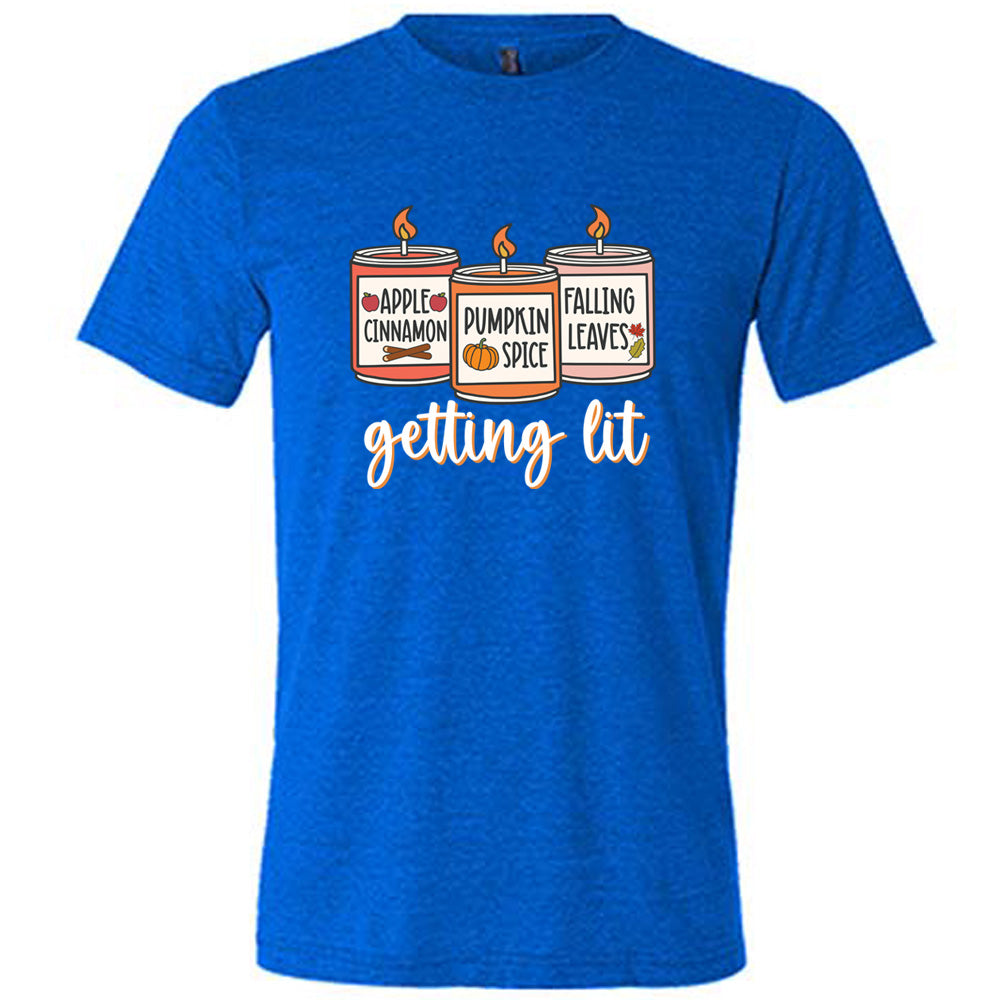 Blue colored shirt with fall scented candles graphic on it that says "getting lit"