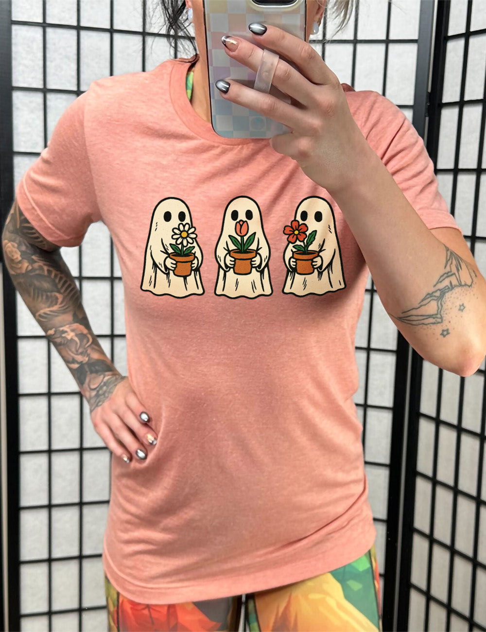 sunset unisex tee with the graphic of three ghosts, each holding a flower pot