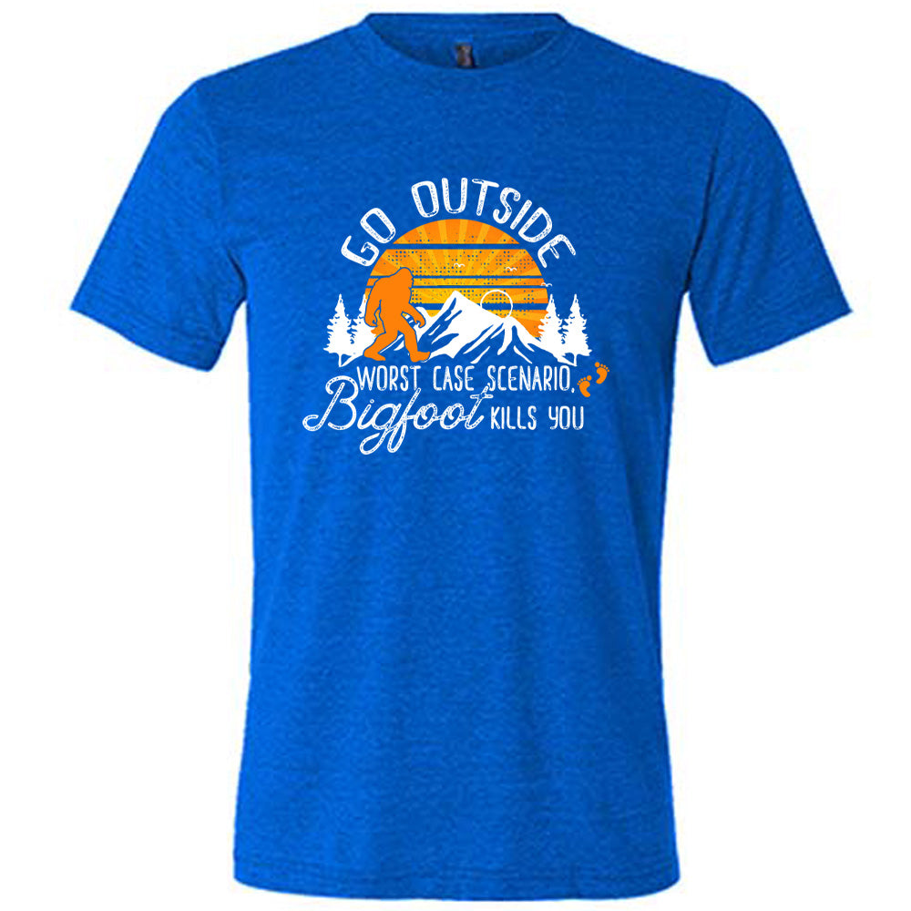 Blue colored shirt with sun and bigfoot in mountains graphic on it that says "Go Outside, Worst Case Scenario Bigfoot Kills You"