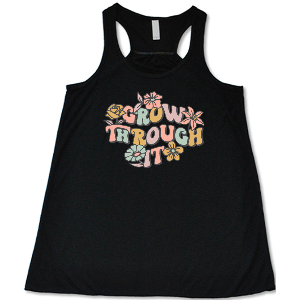 Black colored flowy tank with a flower graphic on it that says "Grow Through It"