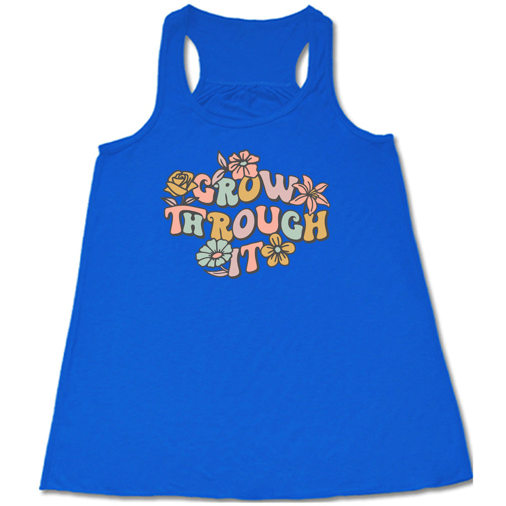 Blue colored flowy tank with a flower graphic on it that says "Grow Through It"