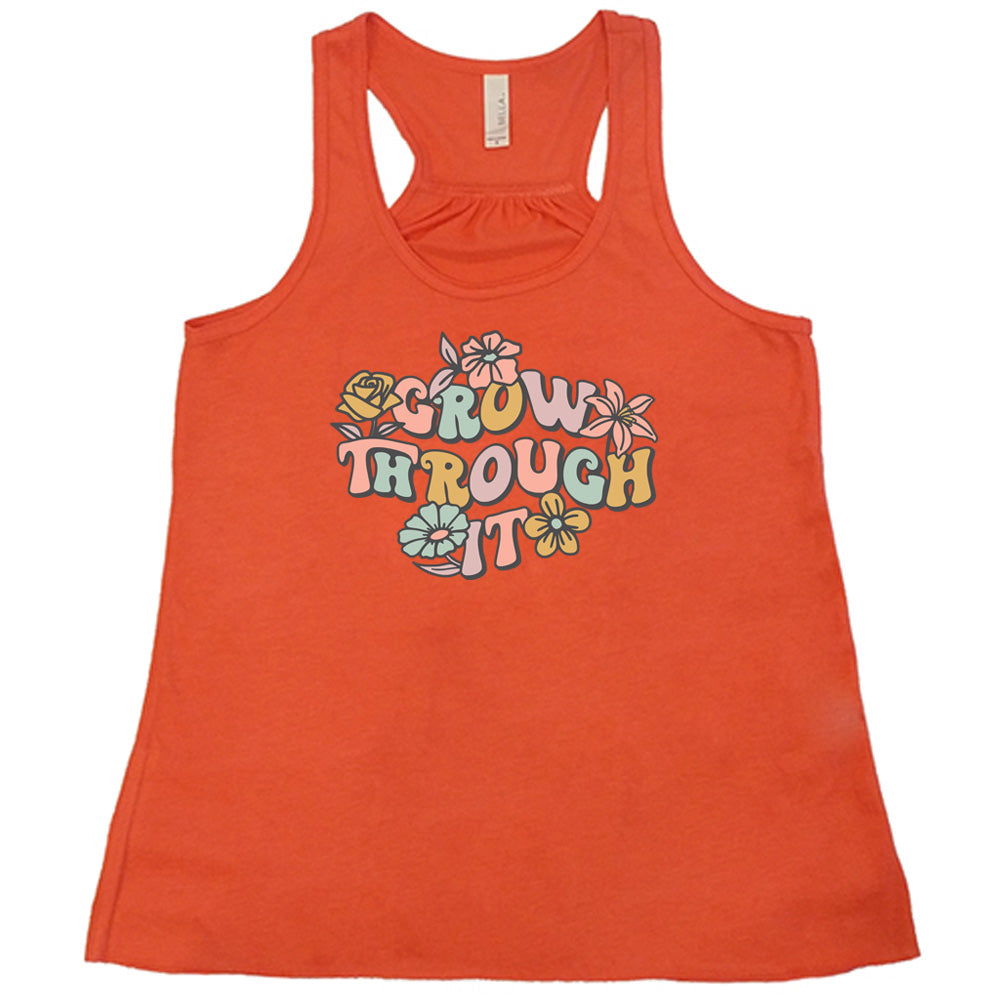 Coral colored flowy tank with a flower graphic on it that says "Grow Through It"