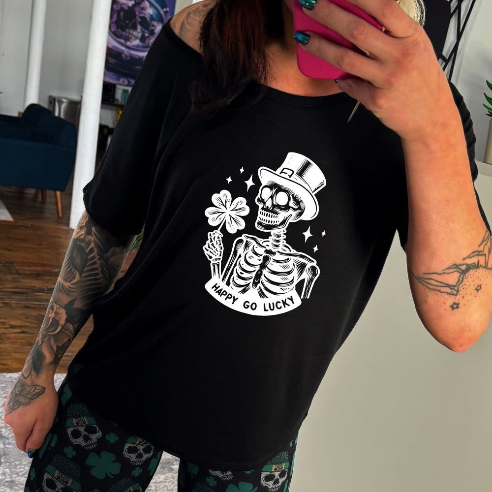 shirt with a skeleton graphic and the text "happy go lucky" on it