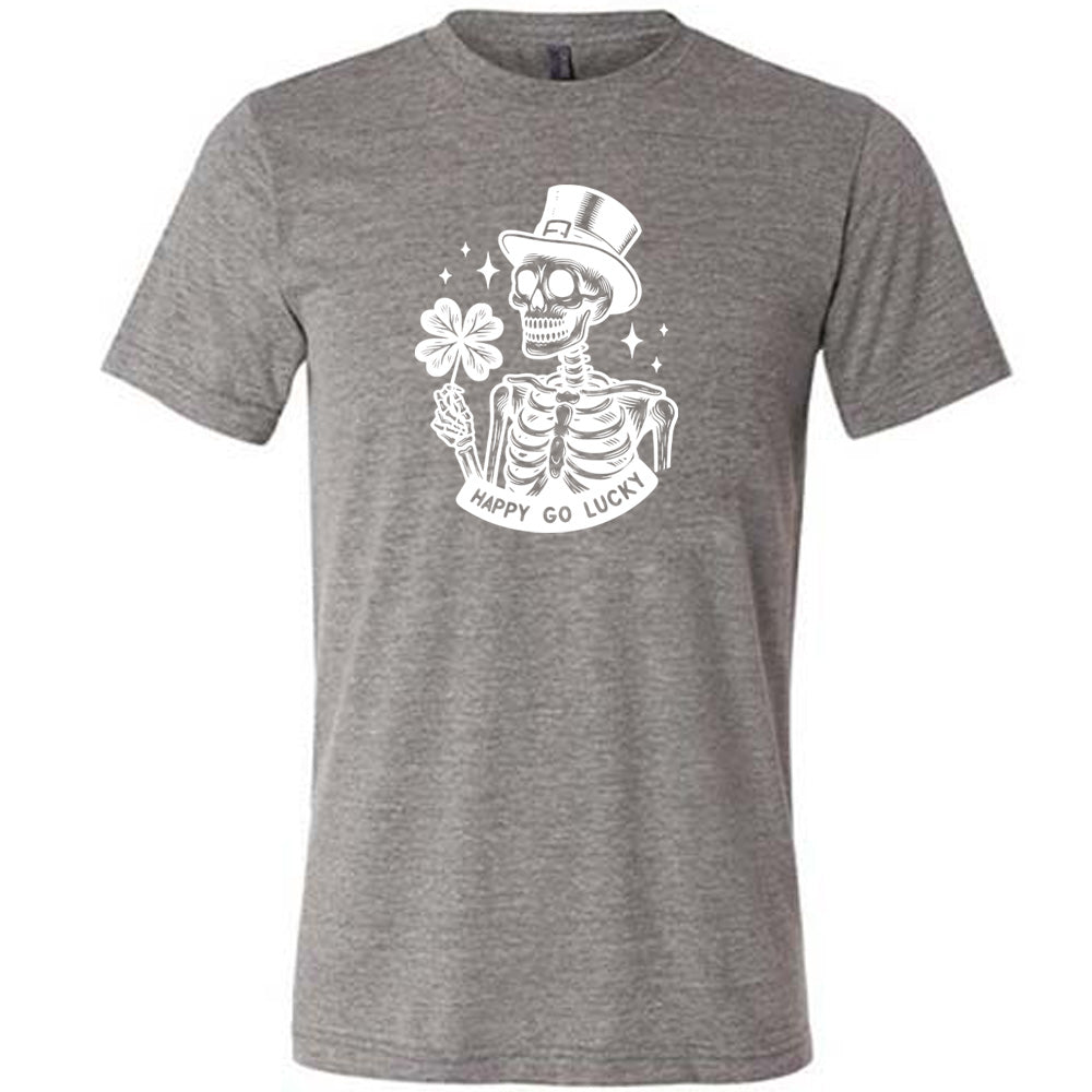 grey shirt with a skeleton graphic and the text "happy go lucky" on it