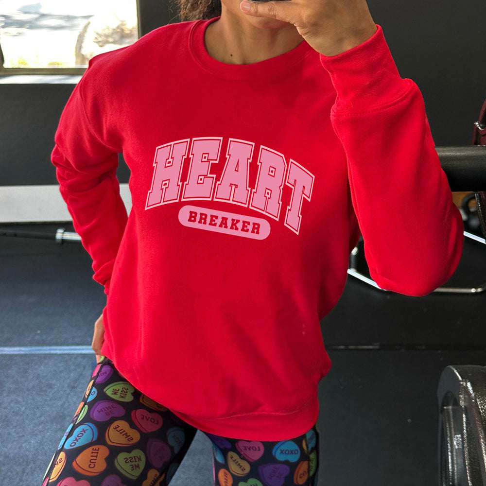 red crewneck with the text "Heart Breaker" on it in pink