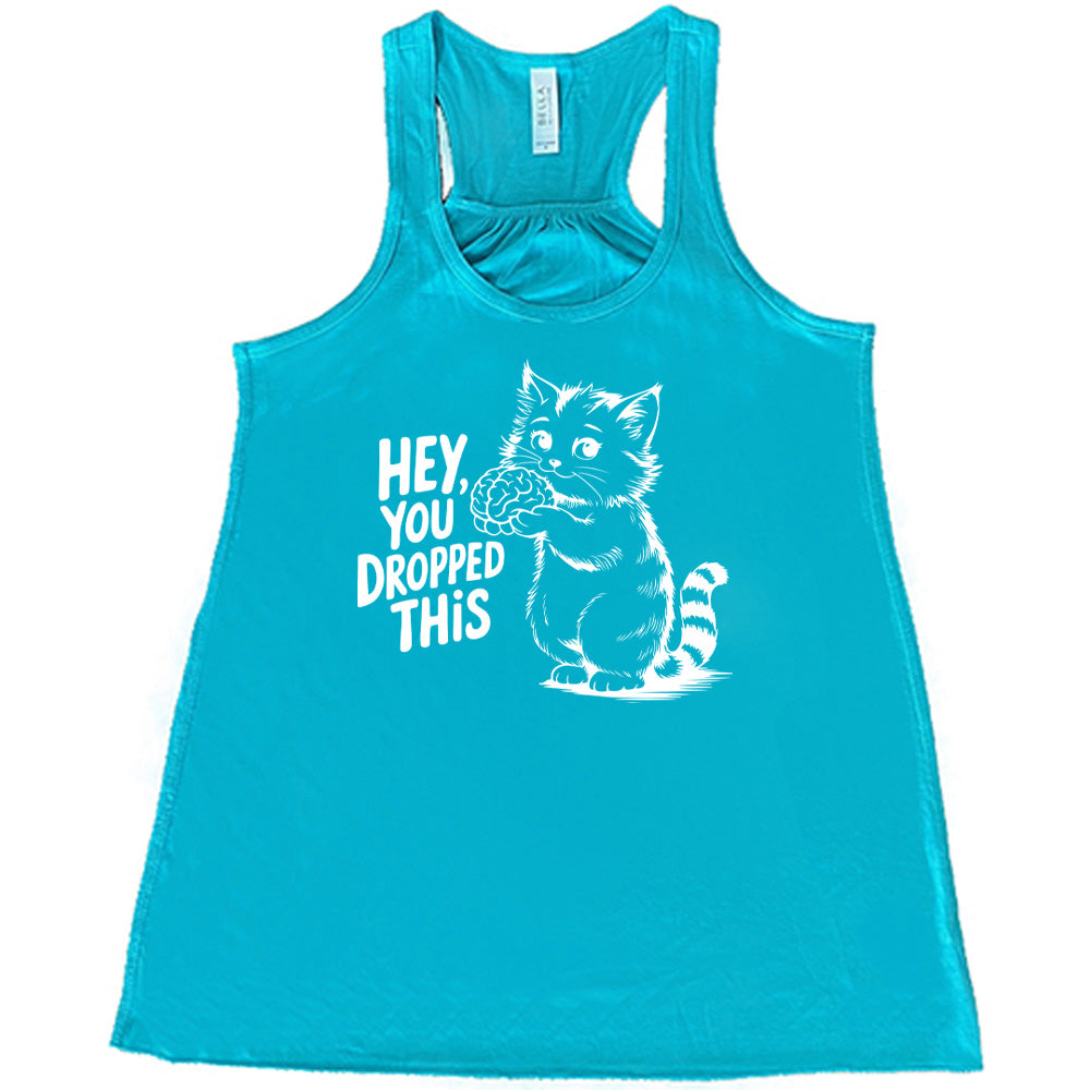 teal flowy tank with the words "Hey, you dropped this" and the graphic of a racoon holding a brain