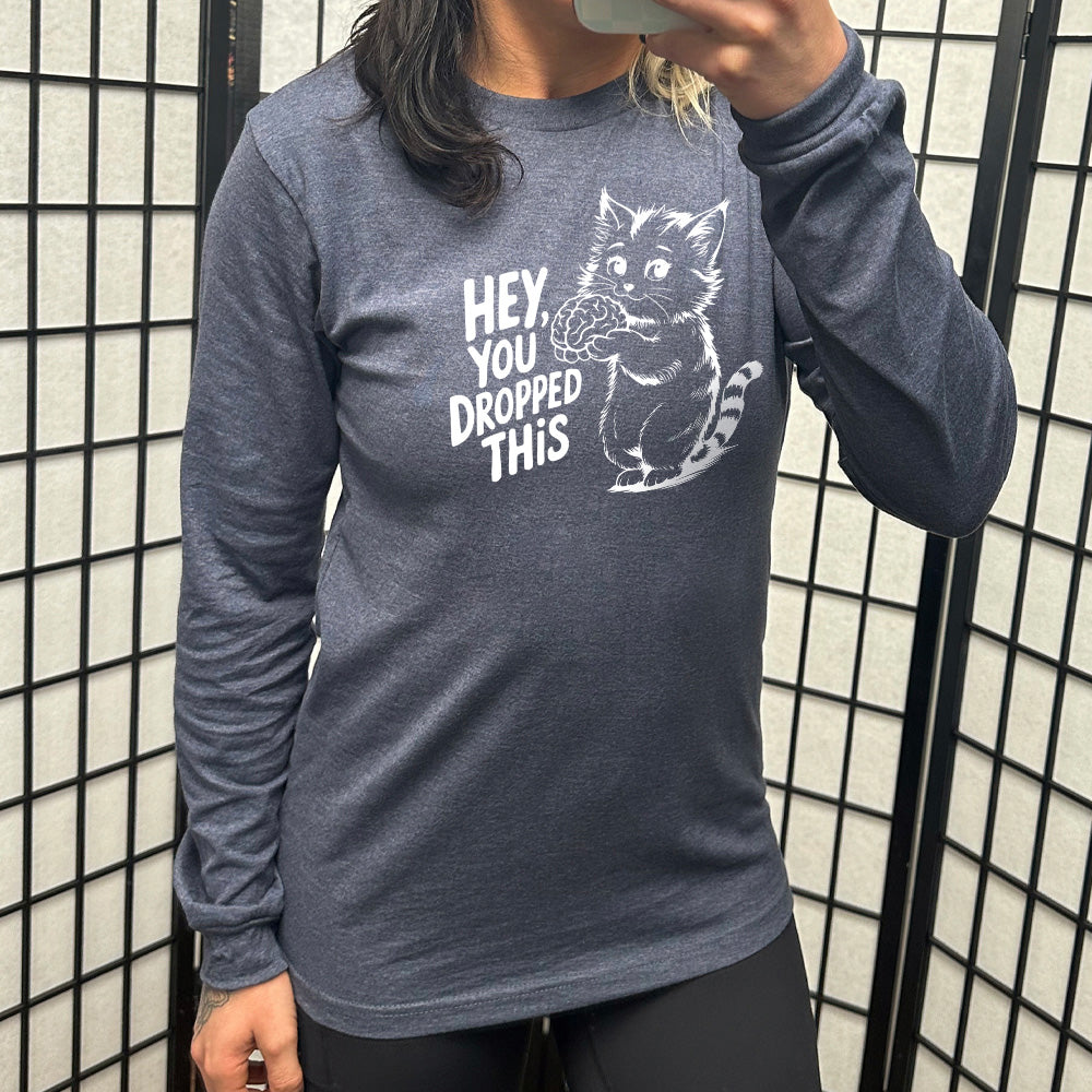 heather navy long sleeve with the words "Hey, you dropped this" and the graphic of a racoon holding a brain
