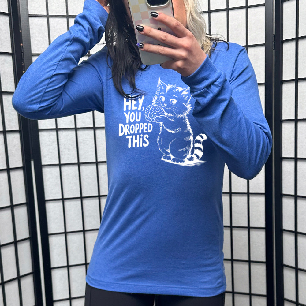 heather true royal long sleeve with the words "Hey, you dropped this" and the graphic of a racoon holding a brain