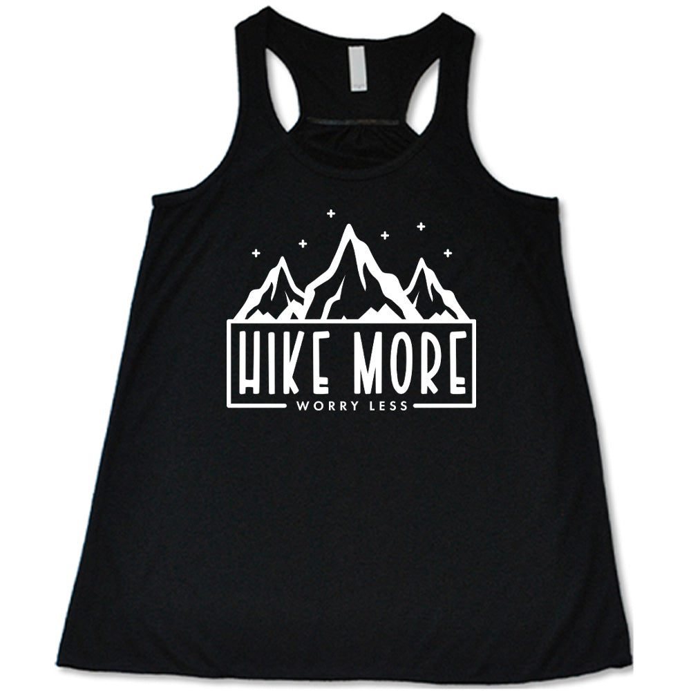 Black colored flowy tank with a mountains and stars graphic on it that says "Hike More Worry Less"