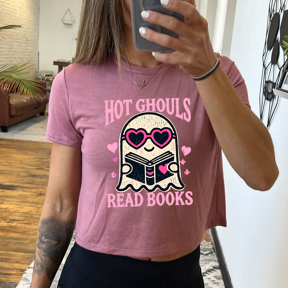 Model wearing mauve colored cropped tee with ghost wearing heart-shaped glasses holding a book graphic on it that says "Hot Ghouls Read Books"
