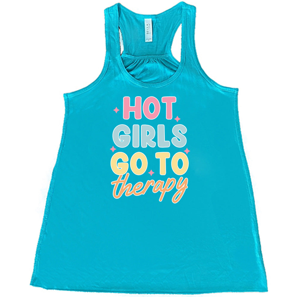 Teal colored flowy tank with a sparkle graphic on it that says "Hot Girls Go To Therapy"