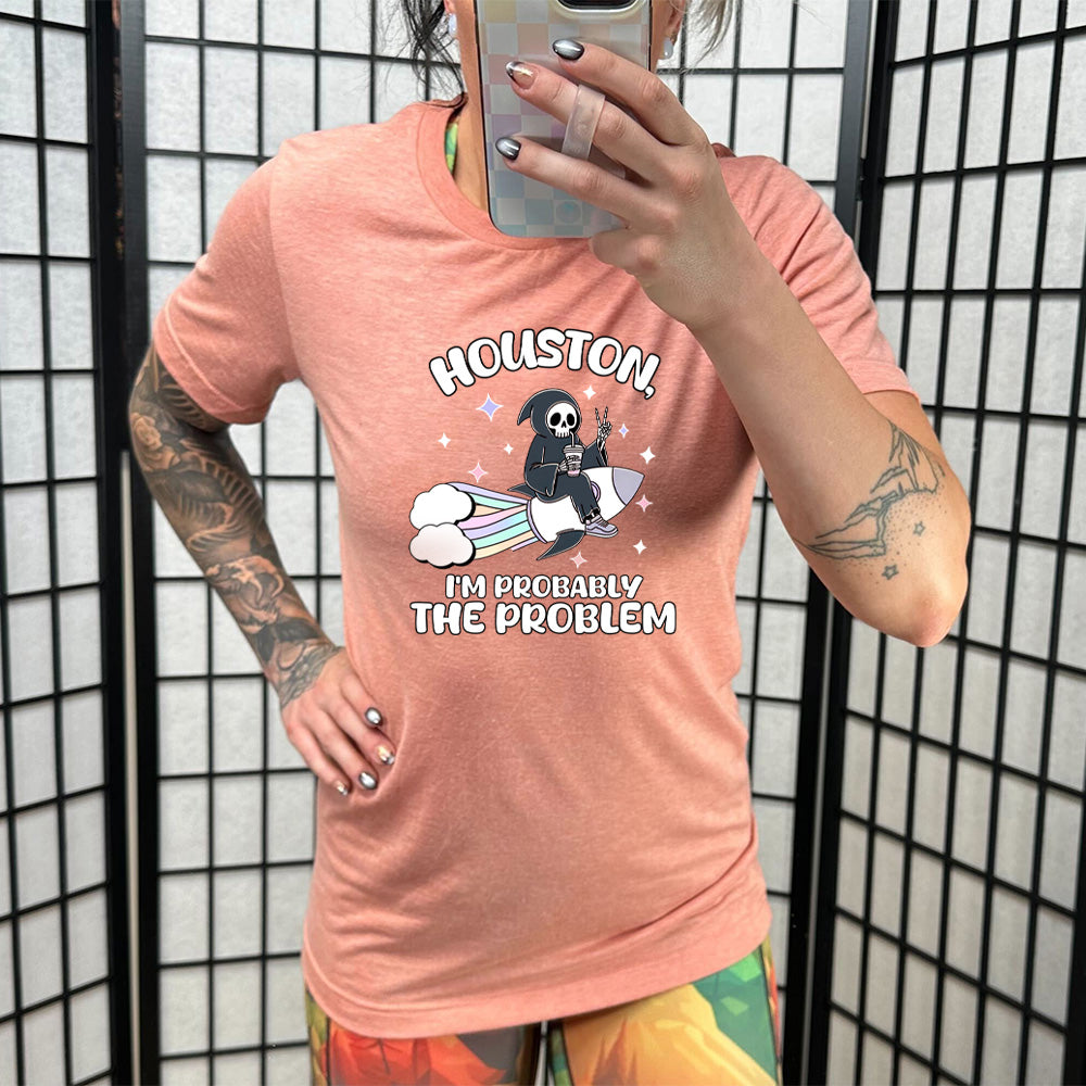 peach shirt with the quote "Houston, I'm Probably the Problem" on it