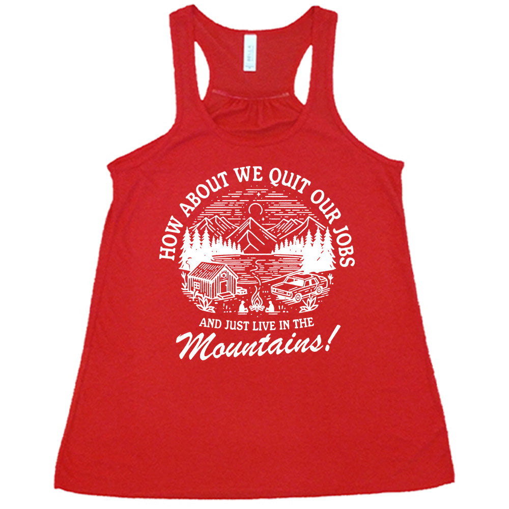 red flowy tank with the words "How about we quit our jobs and just live in the mountains!" on it, with the graphic of a small house, a couple people sitting around a campfire, and an old car in the woods and mountains, with a sky and a couple stars and the moon