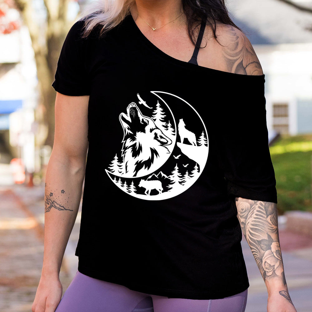 shirt with a wolf howling at the moon in the forest graphic on it