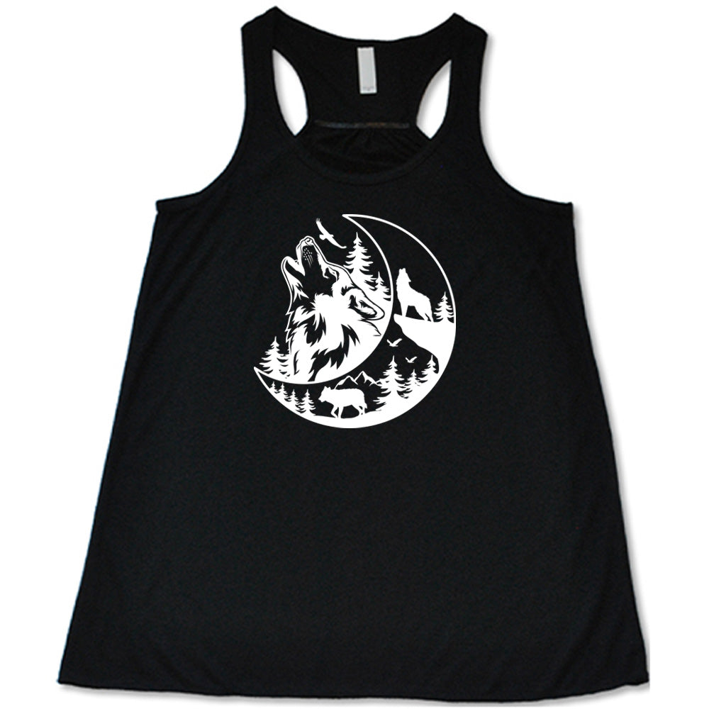 Black colored flowy tank with a wolf howling at the moon in the forest graphic on it