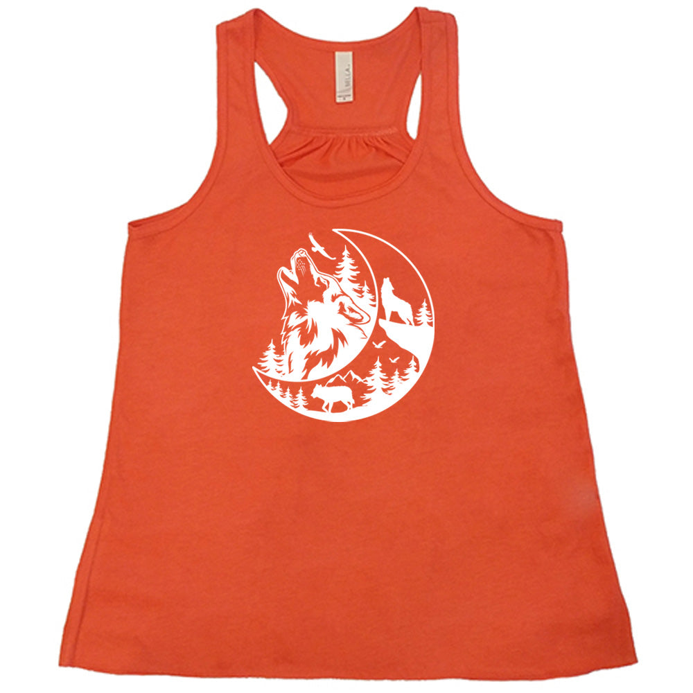 Coral colored flowy tank with a wolf howling at the moon in the forest graphic on it