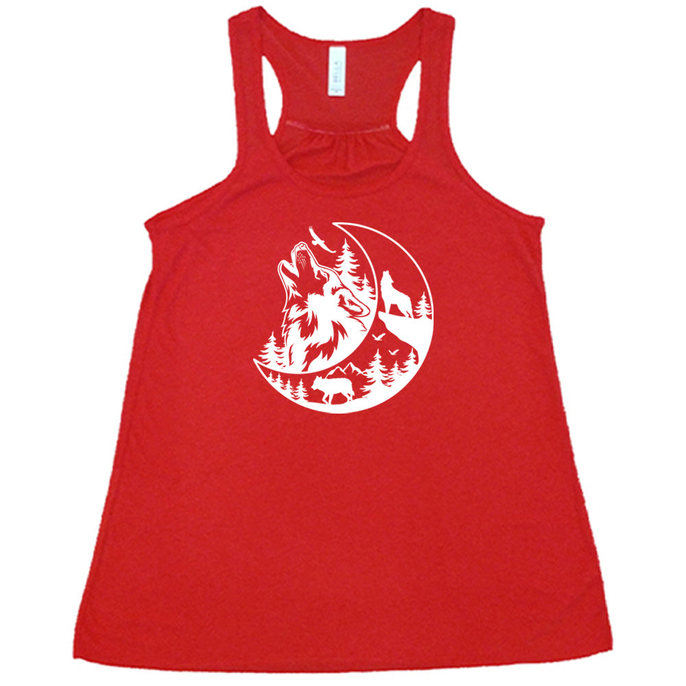 Red colored flowy tank with a wolf howling at the moon in the forest graphic on it