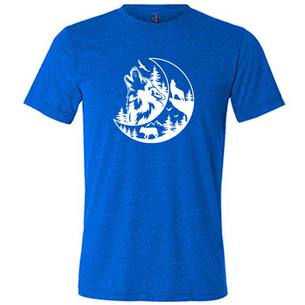Blue colored shirt with a wolf howling at the moon in the forest graphic on it