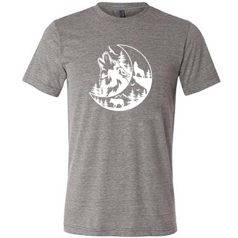 Grey colored shirt with a wolf howling at the moon in the forest graphic on it