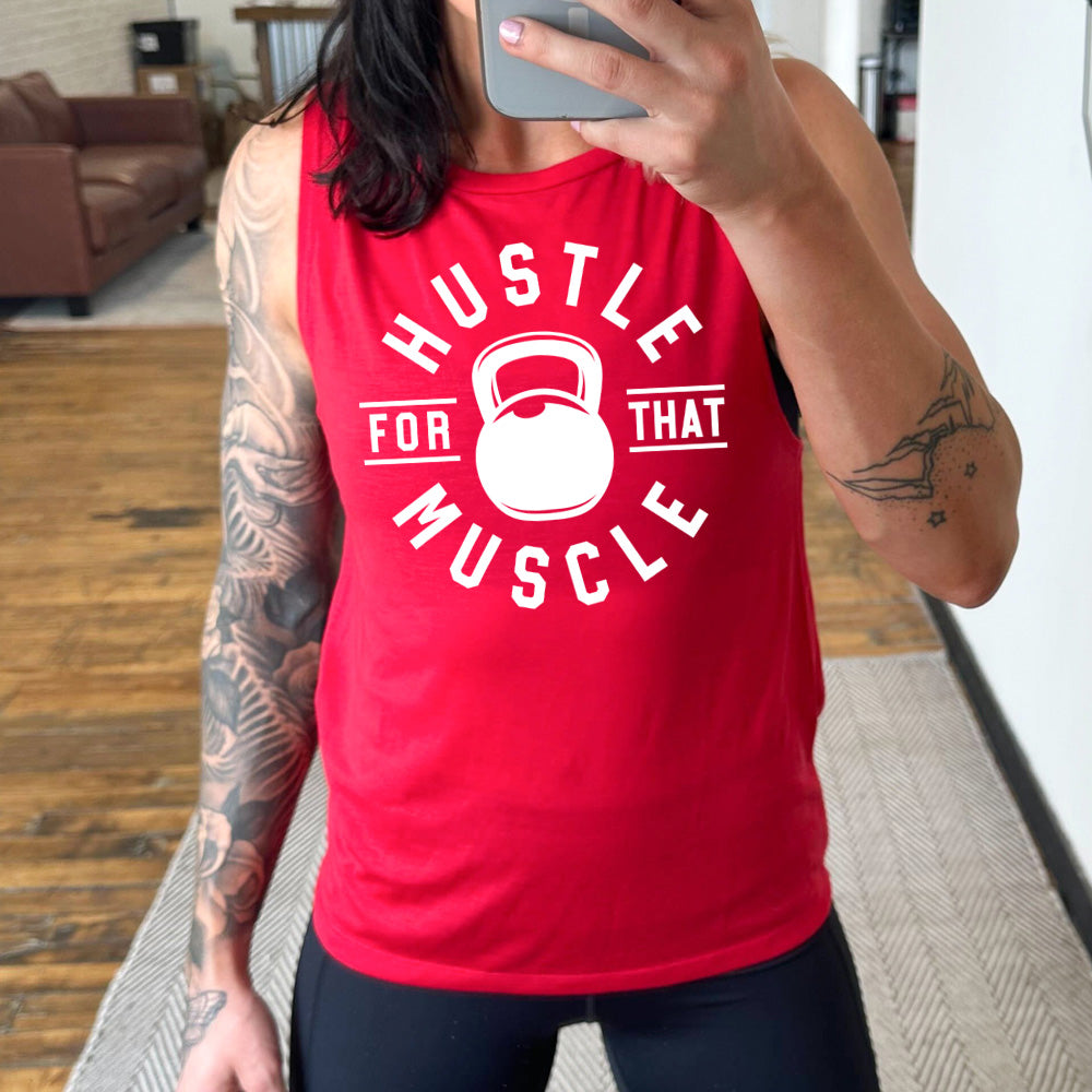red muscle tank with the words "hustle for that muscle" on it, with a kettlebell image