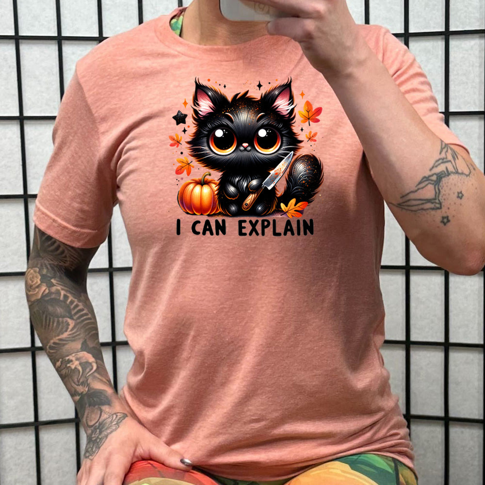 peach shirt with the text "I Can Explain" and a kitten with a knife graphic on it