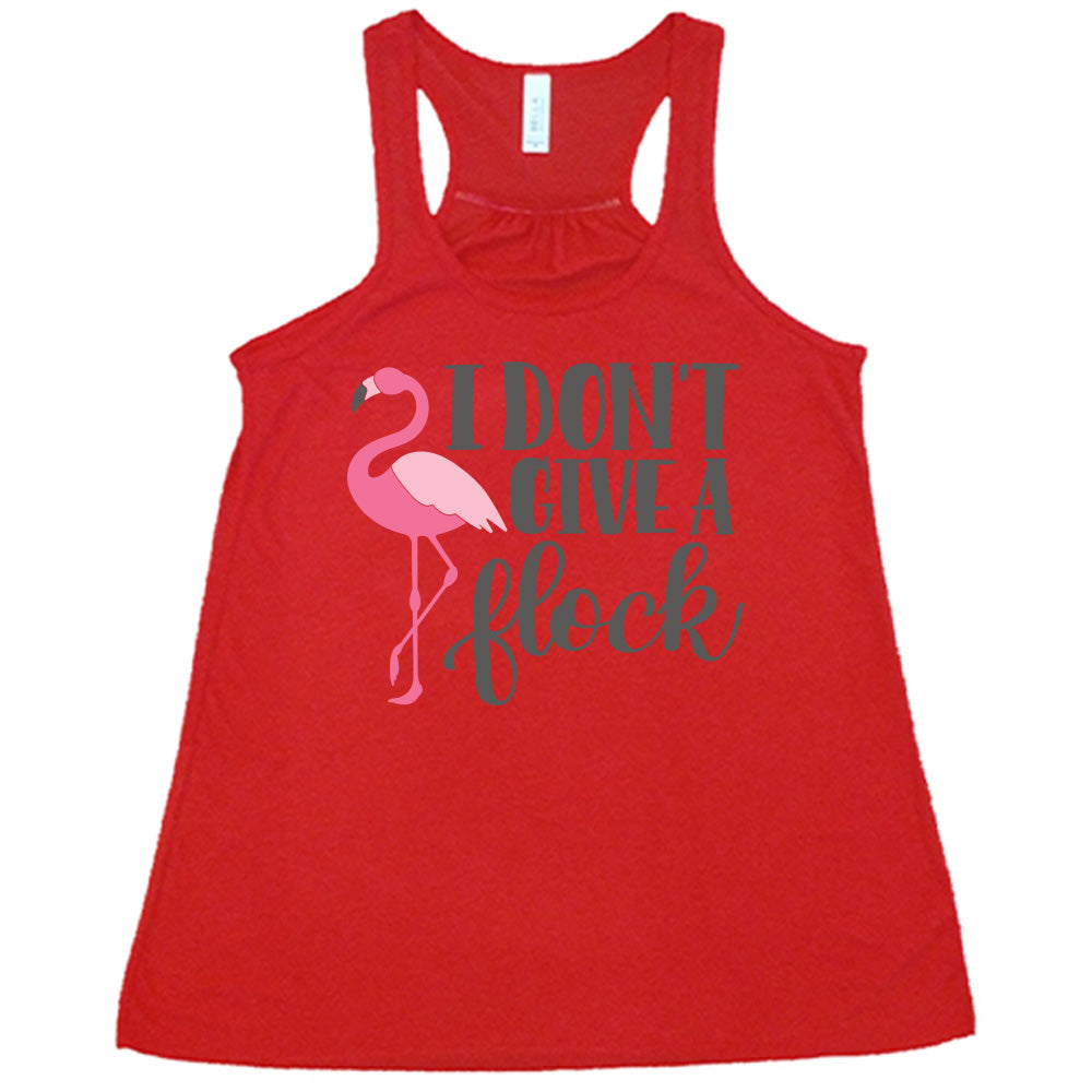 red flowy racerback tank with the words "I don't give a flock" on it, with the graphic of a flamingo next to these words, leg raised
