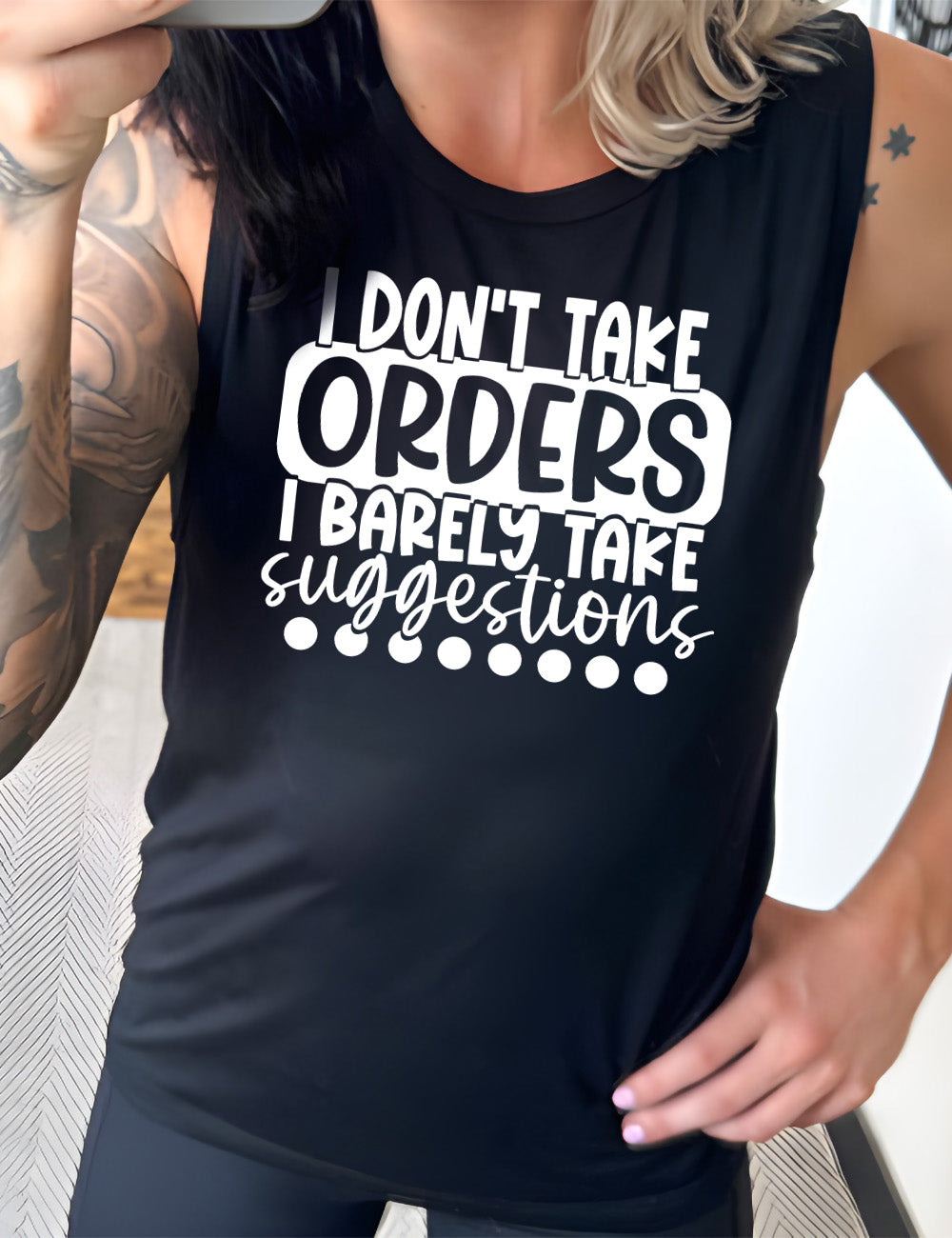 black muscle tank with the words "I don't take orders I barely take suggestions" on it, with a row of dots underneath