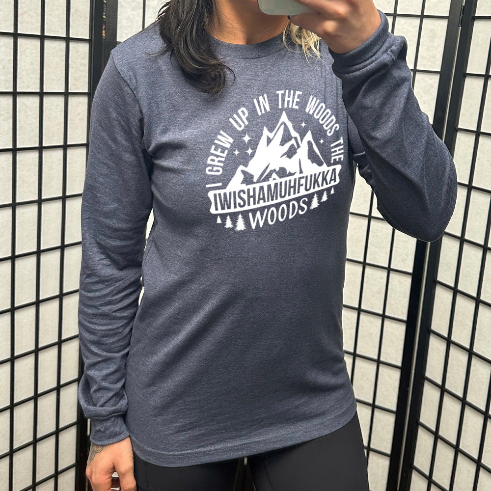 heather navy long sleeve with the words "I grew up in the woods the Iwishamuhfukka woods" on it, with the graphic of mountains and trees and stars
