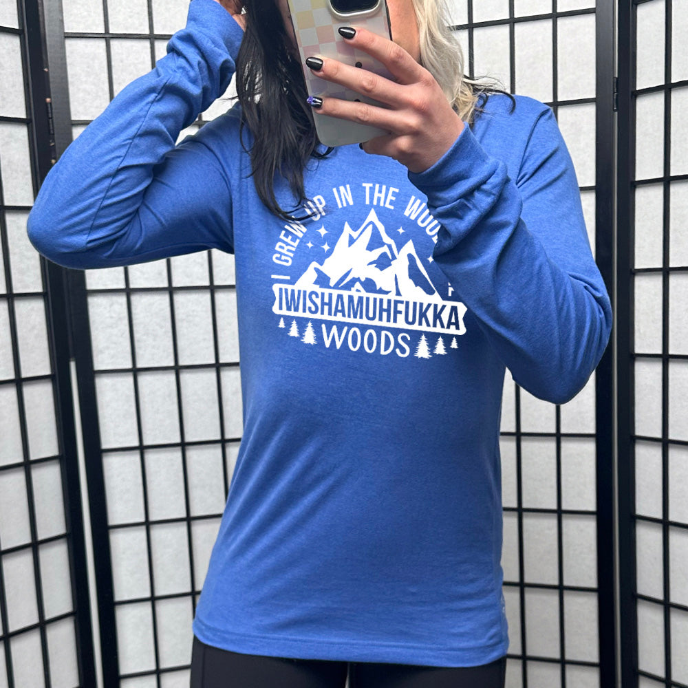 heather true royal long sleeve with the words "I grew up in the woods the Iwishamuhfukka woods" on it, with the graphic of mountains and trees and stars