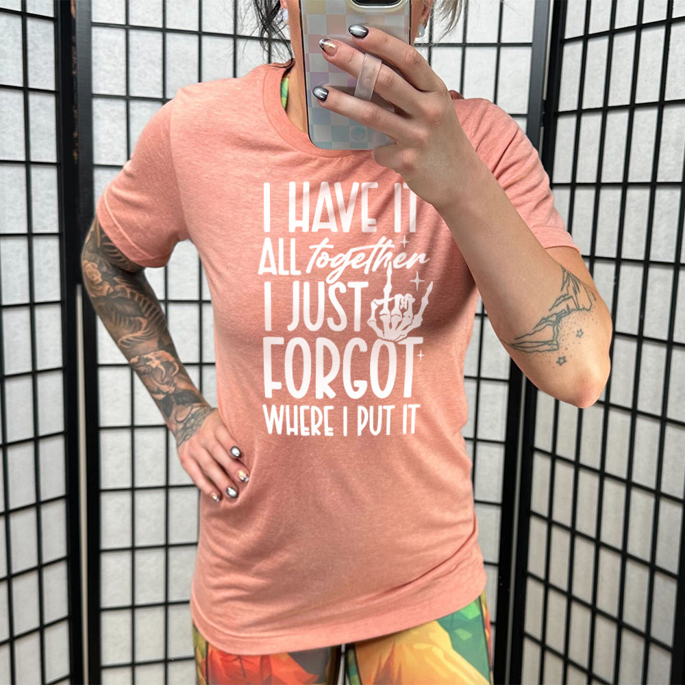 sunset unisex tee with the words "I have it all together I just forgot where I put it" on it, with the graphic of a rocker hand and a few little stars