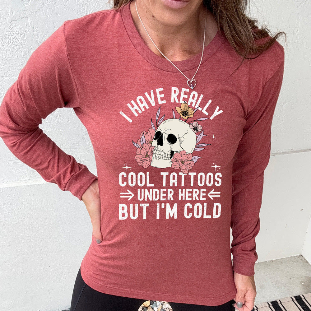 heather clay long sleeve with the words "I have really cool tattoos under here but I'm cold" with the image of a skull in flowers