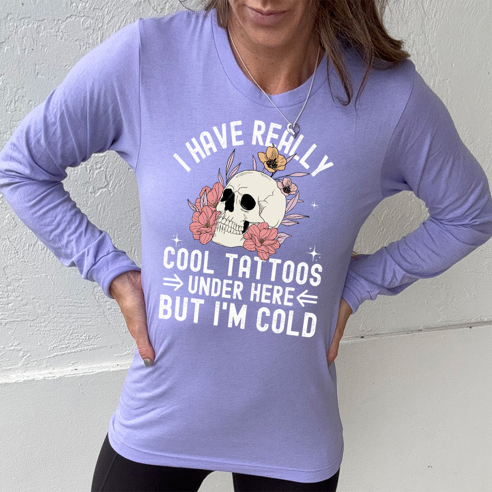 heather dark lavender long sleeve with the words "I have really cool tattoos under here but I'm cold" with the image of a skull in flowers