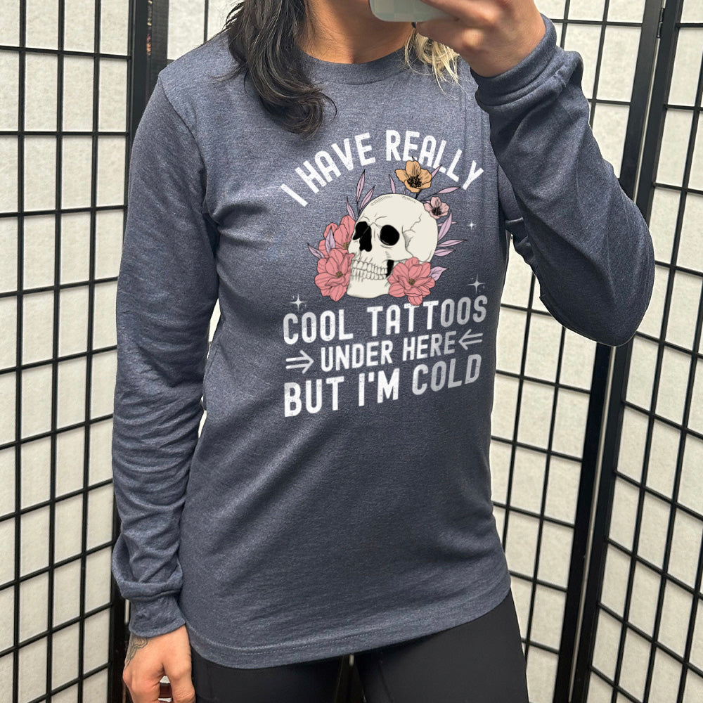 heather navy long sleeve with the words "I have really cool tattoos under here but I'm cold" with the image of a skull in flowers