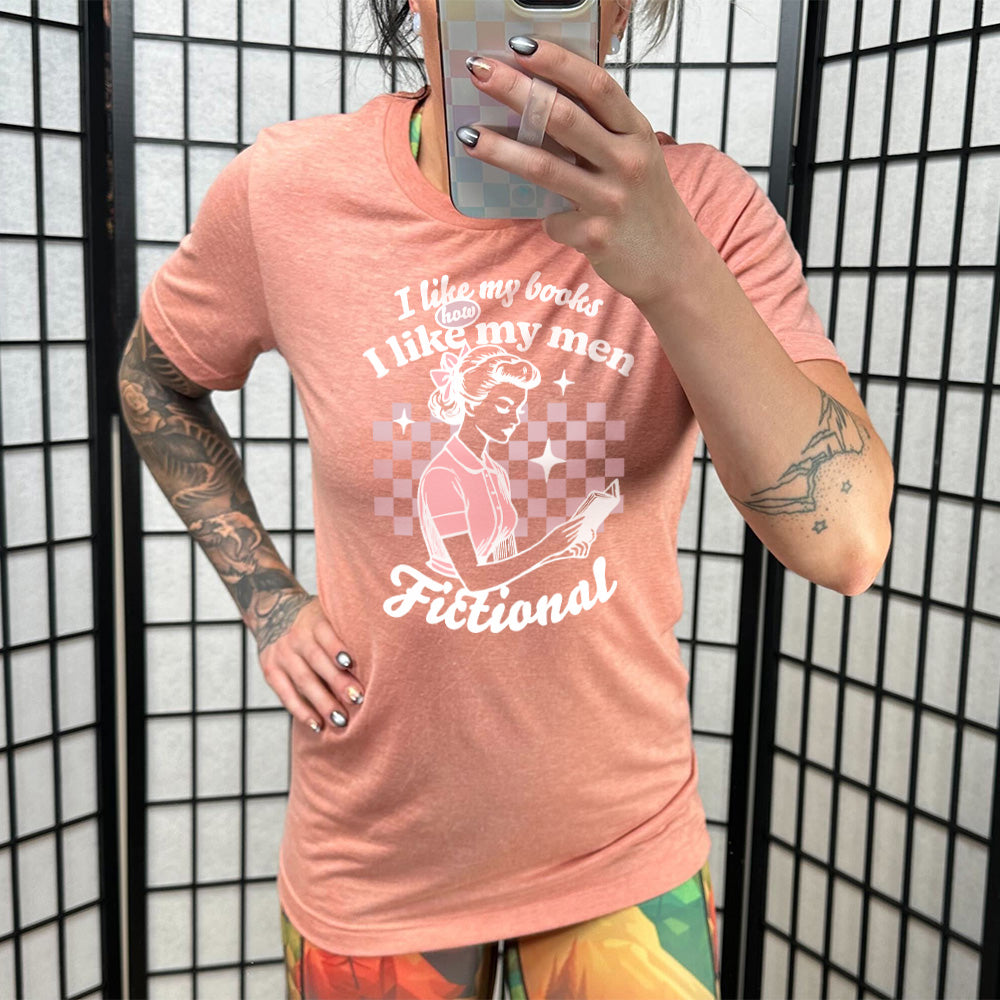 Sunset unisex tee, wording that says I Like My Books How I Like My Men, Fictional, woman reading a book with checkered background
