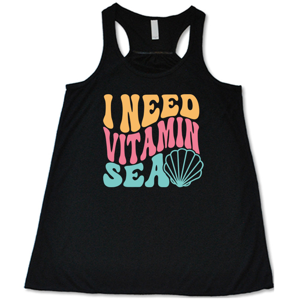 Black colored flowy tank with a shell graphic on it that says "I Need Vitamin Sea"