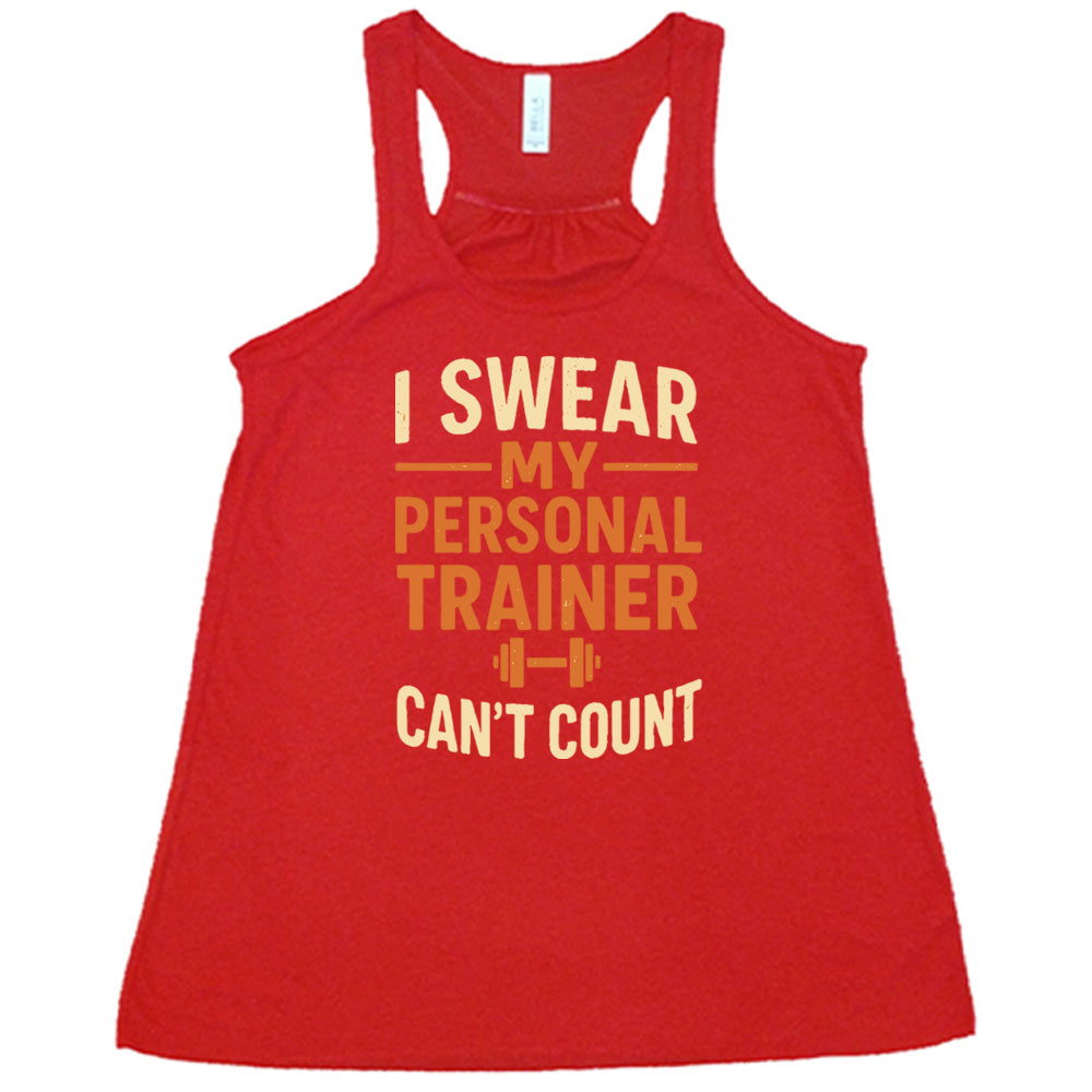 red flowy tank with the words "I swear my personal trainer can't count" on it, and the small image of a barbell