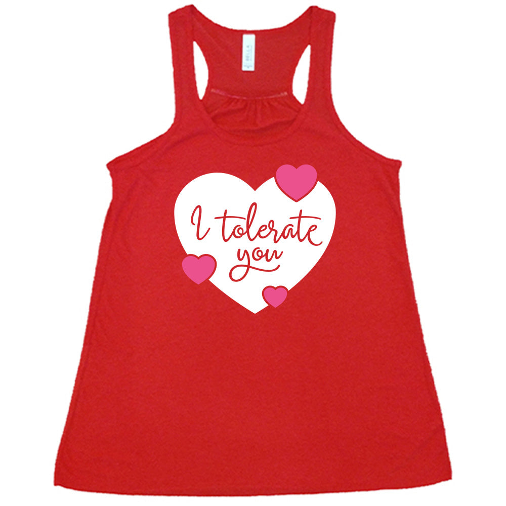 red flowy tank with the words "I tolerate you" in red lettering on it, within a white heart graphic that has three small pink hearts overlapping on its edges