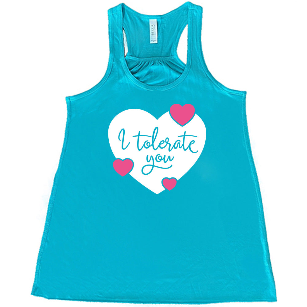 teal flowy tank with the words "I tolerate you" in teal lettering on it, within a white heart graphic that has three small pink hearts overlapping on its edges