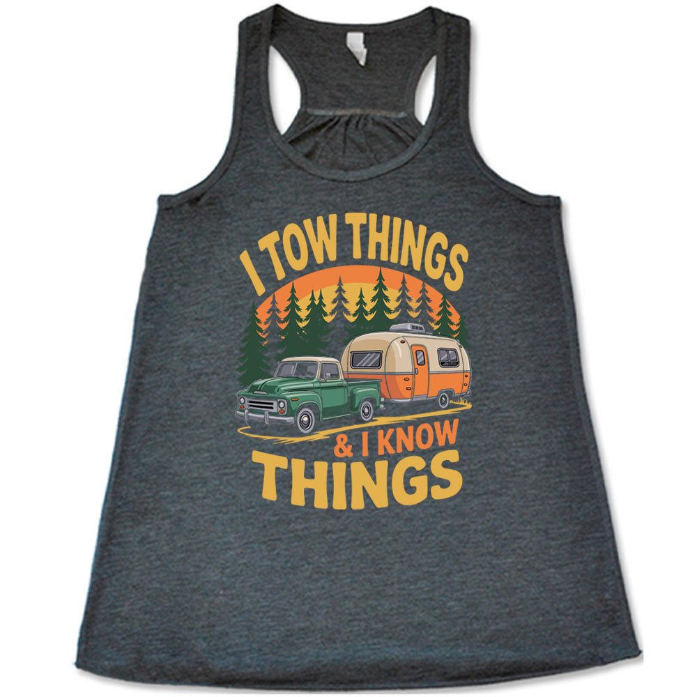 grey flowy tank with the words "I tow things & I know thing" on it, with the graphic of an old-fashioned truck pulling a camper on a road lined with tall trees