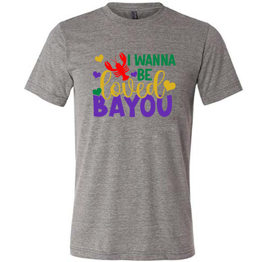 grey unisex tee with the words "I wanna be loved bayou" on it in varied fonts, with the small graphics a few hearts and one lobster
