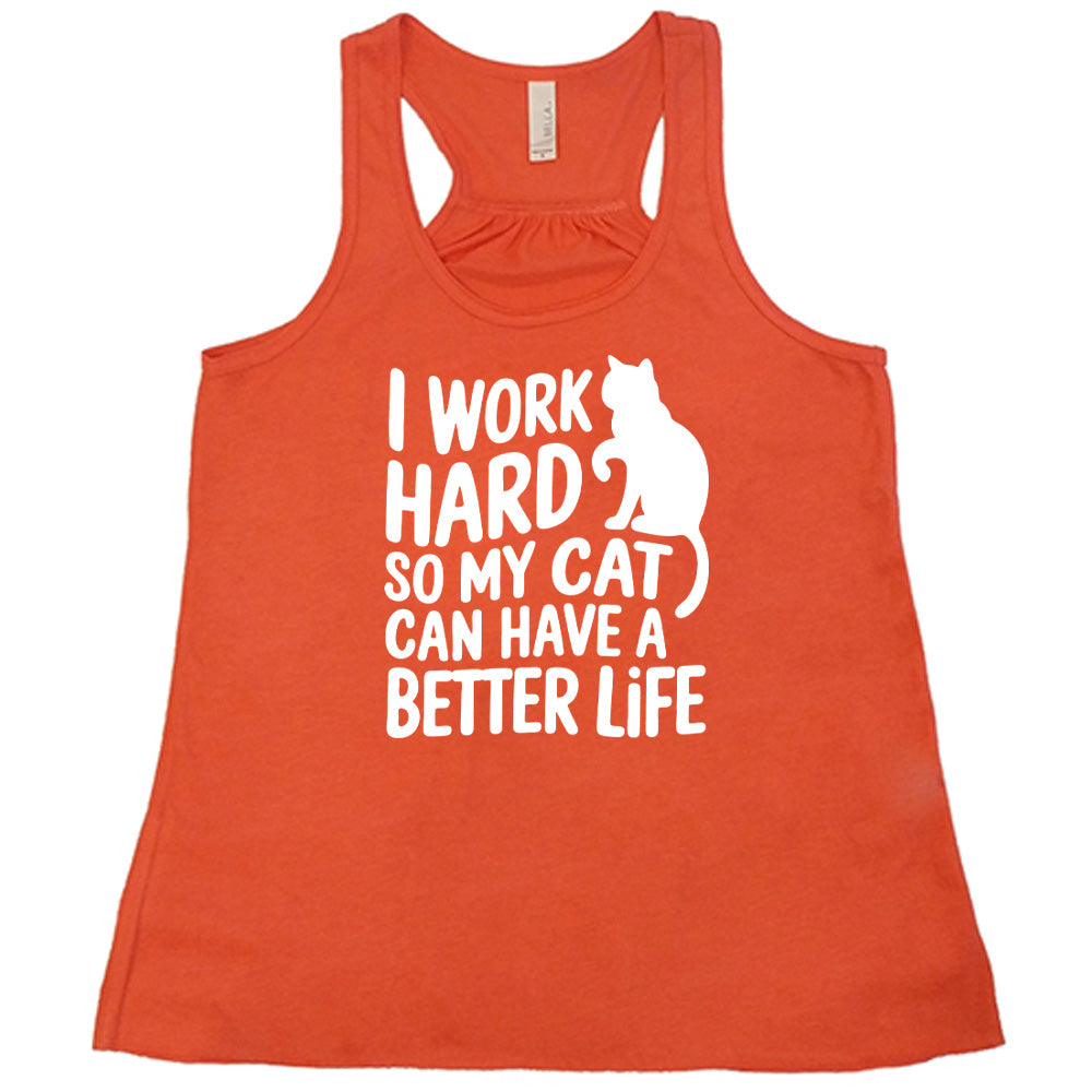 Coral colored flowy tank with cat silhouette graphic on it that says "I Work Hard So My Cat Can Have A Better Life"