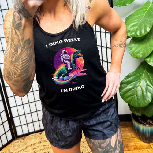 model wearing a black racerback shirt with a astronaut and dinosaur graphic with the quote "I Dino What I'm Doing" on it