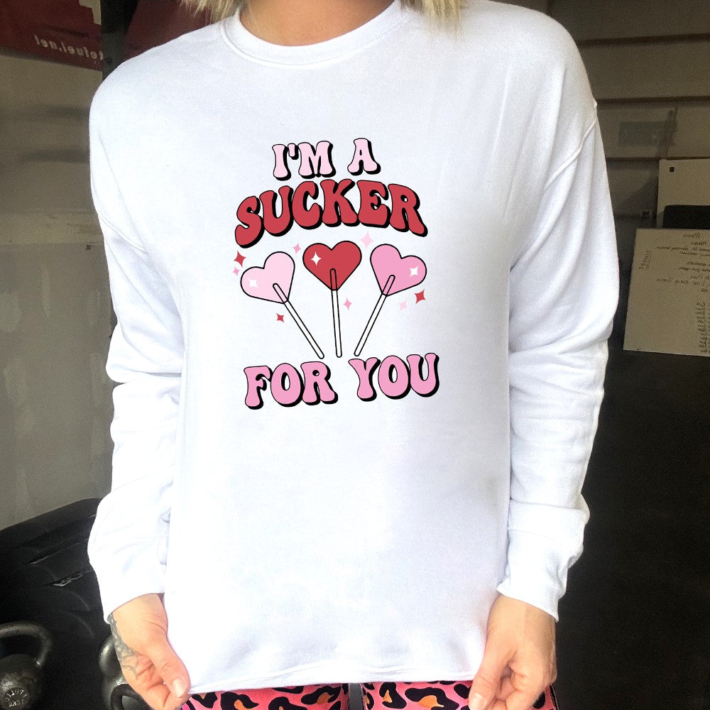 white crewneck with the text "I'm A Sucker For You" on it