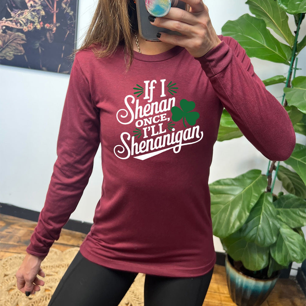 heather cardinal long sleeve with the words "if I shenan once, I'll shenanigan" on it, with the graphic of a shamrock