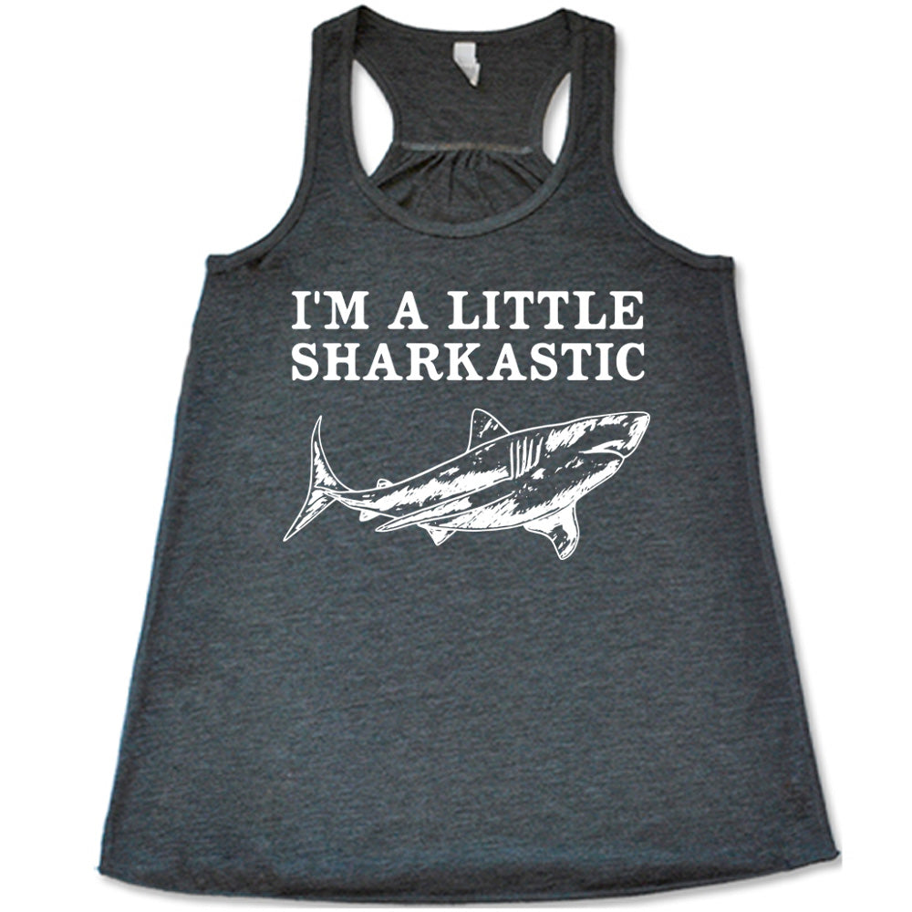 grey racerback flowy tank with the words "I'm a little sharkastic" on it, over the graphic of a shark
