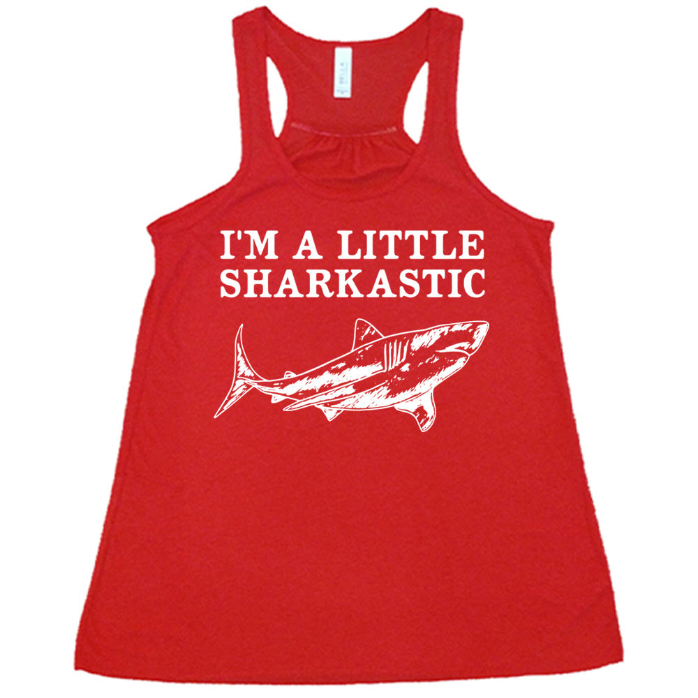 red racerback flowy tank with the words "I'm a little sharkastic" on it, over the graphic of a shark